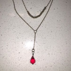 Gold necklace with red gem